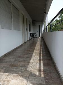 a porch of a house with a table and chairs at La Residenza in Santa Ana