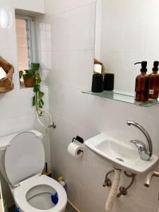 a bathroom with a toilet and a sink at Dotan's Boutique Studios - By The Beach! in Tel Aviv