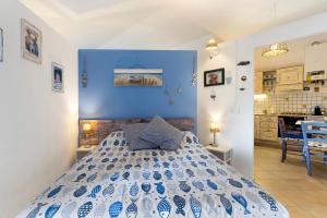 a bedroom with a blue and white bed in a room at Attico con terrazza a Viareggio in Viareggio