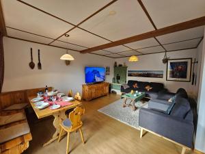 ein Wohnzimmer mit einem Tisch und einem Sofa in der Unterkunft Chalet Aargovia South in Wengen