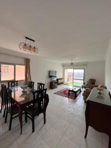a living room with a table and chairs and a couch at Cozy holiday apartment in Maadi in Cairo
