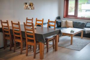 a dining room with a table and chairs and a couch at Apartment in Sørvágur in Sørvágur