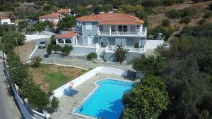 an aerial view of a house with a swimming pool at Villa Karras in Pythagoreio