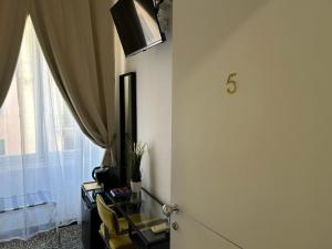 a room with a door and a window and a desk at Brignole Rooms in Genoa