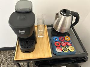 a coffee maker sitting on top of a table next to a coffee pot at Brignole Rooms in Genoa