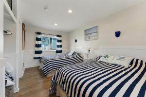 two beds in a room with white and blue stripes at 415 E Atlanta Ave, Unit 107 in Wildwood Crest