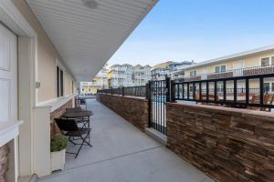 a balcony with chairs and a brick wall at 415 E Atlanta Ave, Unit 107 in Wildwood Crest