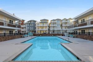 a swimming pool in front of some apartment buildings at 415 E Atlanta Ave, Unit 107 in Wildwood Crest