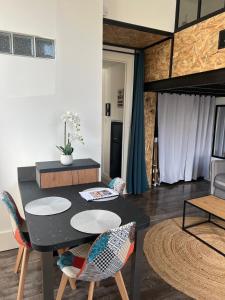 a living room with a black table and chairs at Le Terminus in Aix-les-Bains