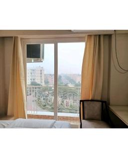 a room with a window with a view of a balcony at Radhe Krishna Luxury stay in Mathura