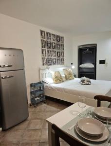 a room with a bed and a kitchen with a table at Good Times Accomodation Cuneo in Cuneo