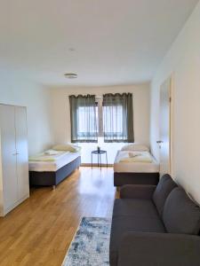 a living room with two beds and a couch at Vienna´s Danube Apartments in Vienna