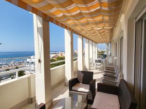 a balcony with chairs and a view of the ocean at Marbella edificio Puerto Azul in Marbella