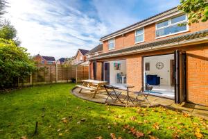 a patio with a table and chairs in a yard at 5 bed detached - Worsley, Manchester in Worsley