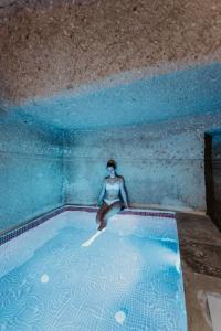 uma mulher está sentada numa piscina em Angel View Suites em Goreme