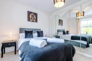 a bedroom with two beds and a mirror at 5 bed detached - Worsley, Manchester in Worsley