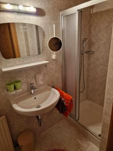 a bathroom with a sink and a shower at Ferienhotel Lindenhof in Leogang