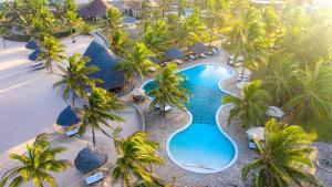 an aerial view of a resort pool with palm trees at Ocean Beach Resort & Spa ASTON Collection Hotels in Malindi