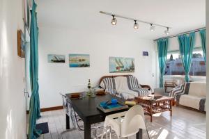 a living room with a table and a couch at Good Wave House in Vilamoura