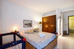 a bedroom with a bed with two towels on it at Good Wave House in Vilamoura