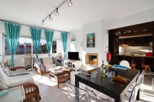 a living room with a table and chairs at Good Wave House in Vilamoura