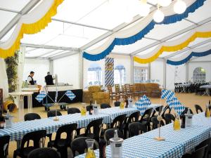 a banquet hall with blue and white tables and chairs at Morada Hotel Isetal in Gifhorn