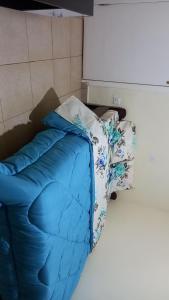 a blue sleeping bag sitting on a bed in a room at Tommy's Budget Rooms in Kigali