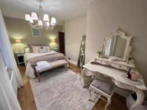 a bedroom with a bed and a mirror and a sink at Luxury apartment, 60 High St, St Martins in Lincolnshire