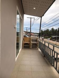 a balcony with a bench and a view of a street at Hassana Apartment in Ban Ai Dao +12 photos