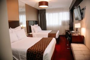 Cama ou camas em um quarto em Hotel Carrera