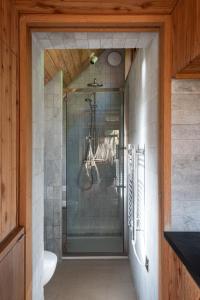 a bathroom with a shower with a glass door at Atlantis in Holbeton
