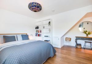 a bedroom with a bed and a desk and a mirror at The Lookout @ Highdown in Braunton