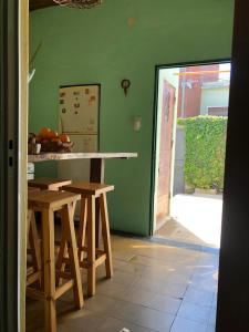 a kitchen with a table and stools in a room at Hostal - Sueños del Rio in Concepción del Uruguay