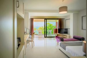 a hotel room with two beds and a balcony at Balcony Boutique Hotel in Tsilivi