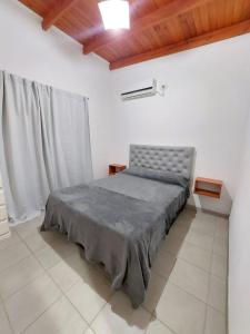 a bedroom with a bed in a white room at La casita del campo in Colón