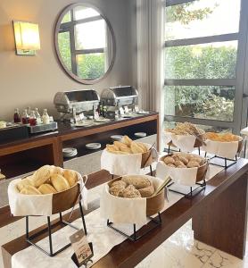 a table with several baskets of different types of bread at Eurostars Oporto in Porto