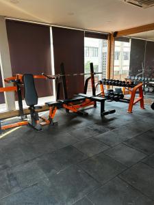 a gym with several treadmills and chairs in a room at River Front Property in Ahmedabad
