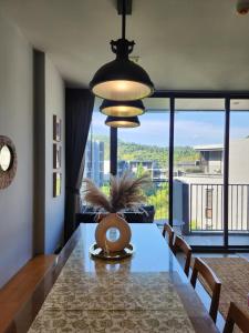 a dining room with a table and a large window at Mountain View Suite at The Valley Khaoyai in Ban Huai Sok Noi