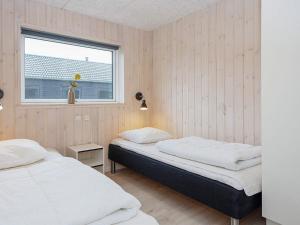 two beds in a room with a window at Luxury Retreat with Pool - By Traum Ferienwohnungen in Kongsmark +49 photos