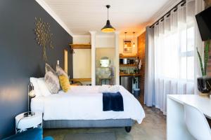 a bedroom with a white bed and a window at River View in Potchefstroom