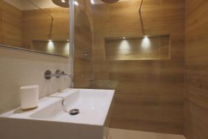 a bathroom with a white sink and a shower at Torregalli- Terrace Apartment in Florence