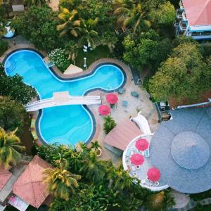 an aerial view of a swimming pool with a resort at Sashas Holiday Village in Vagator