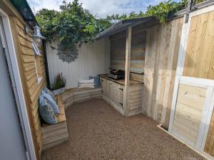 a wooden shed with a table in it at La Cachette in Blackpool