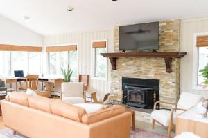 a living room with a couch and a fireplace at Cozy Lakeside Fall Escape; Applepick, Hike, Winery in Greenwood Lake