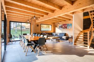 a dining room and living room with a wooden ceiling at Chalet Frantz'y in Saint-Jean-d'Aulps