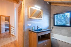 a bathroom with a sink and a mirror and a tub at Chalet Frantz'y in Saint-Jean-d'Aulps +29 photos