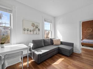 a living room with a couch and a table at Shadyside, Pittsburgh, Modern and Bright 1 Bedroom Unit4 with Free Parking in Pittsburgh