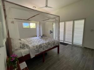 Salama Eco-Lodge and Hostel في Mitsamiouli: غرفة نوم بسرير مع مظلة