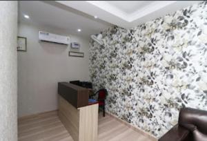a living room with a flower patterned wall at Nilansh homes and hotels in Lucknow