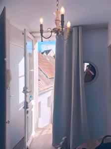 a room with a window with a curtain and a mirror at Kasaloc in Maintenon +42 photos